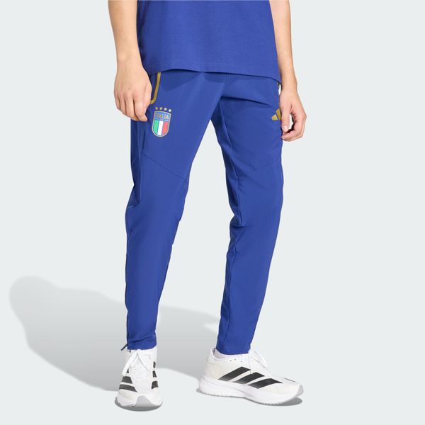 Spodnie Włochy Tiro Travel. Niebieskie spodnie materiałowe męskie Adidas, bez wzorów, sportowe. Za 329.00 zł.