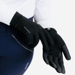 Rękawiczki jeździeckie 100. Czarne rękawiczki dziecięce FOUGANZA, z dzianiny, bez ramiączek. Za 39.99 zł.