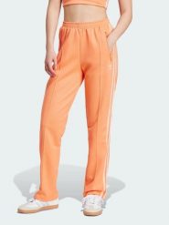 Adidas Spodnie dresowe w kolorze pomarańczowym rozmiar: XS. Pomarańczowe spodnie dresowe damskie Adidas, xs, bez wzorów, z dresówki. Za 123.25 zł.