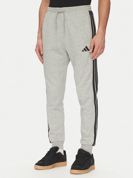 Adidas Spodnie dresowe Essentials 3-Stripes JE6318 Szary Regular Fit. Szare spodnie dresowe męskie Adidas, bez wzorów, z dresówki. Za 159.99 zł.