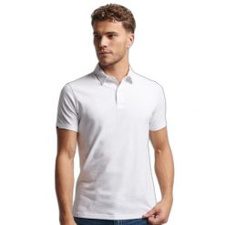 Koszulka polo z dżerseju Superdry Studios. Białe koszulki polo męskie Superdry., m, bez wzorów, z dżerseju, bez ramiączek. W wyprzedaży za 176.45 zł.