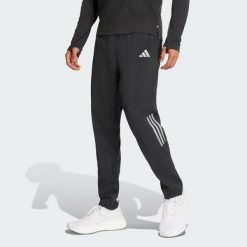 Spodnie adi365 Iconic/// Astro Running. Czarne spodnie materiałowe męskie Adidas, bez wzorów, z materiału, eleganckie, z standardowym stanem. Za 299.00 zł.