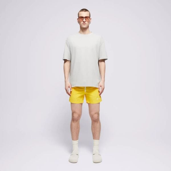 SPODENKI MĘSKIE PLAŻOWE CHAMPION-SZORTY BEACHSHORT ZA KOLANO KOLOR ŻÓŁTY. Żółte szorty męskie CHAMPION, na lato, bez wzorów, z materiału, eleganckie. Za 65.88 zł.