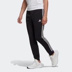Spodnie adidas Essentials French Terry Tapered Cuff 3-Bandes. Białe spodnie sportowe męskie Adidas, z bawełny. Za 163.99 zł.