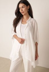 Biała Zwiewna Koszula Letnia Oversize z Bawełny o Nietoperzowym Kroju Canomela. Białe koszule damskie Born2be, na lato, l, bez wzorów, z bawełny, eleganckie, bez kołnierzyka, bez ramiączek. Za 139.99 zł.