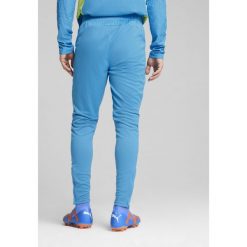 Męskie spodnie treningowe Manchester City PUMA Magic Blue Yellow Glow. Niebieskie spodnie dresowe męskie Puma, bez wzorów, z dresówki. W wyprzedaży za 182.50 zł.