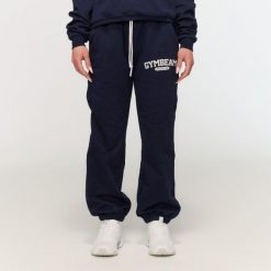 Spodnie dresowe damskie fitness oversize niebieskie Varsity. Niebieskie spodnie sportowe damskie GYMBEAM, l, z bawełny, na fitness i siłownię. Za 126.90 zł.