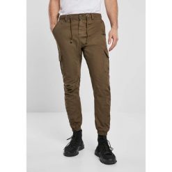 Spodnie Urban Classics cargo jogging. Brązowe spodnie materiałowe męskie Urban Classics, bez wzorów, z bawełny, klasyczne. Za 212.10 zł.