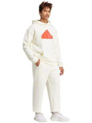 Adidas Spodnie dresowe "Future Icons Badge of Sport" w kolorze kremowym rozmiar: M. Brązowe spodnie dresowe męskie Adidas, bez wzorów, z dresówki. Za 118.28 zł.