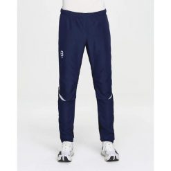 Spodnie narciarskie Daehlie Sportswear Winner 4.0. Niebieskie spodnie materiałowe męskie DAEHLIE, bez wzorów, z materiału. Za 497.50 zł.