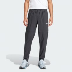 Spodnie Own the Run 3-Stripes. Czarne spodnie sportowe męskie Adidas, z materiału. Za 319.00 zł.