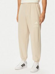 Adidas Spodnie dresowe Seasonal Essentials Collegiate French Terry Cuffed KF4265 Beżowy Regular Fit. Brązowe spodnie dresowe męskie Adidas, bez wzorów, z bawełny. Za 239.99 zł.