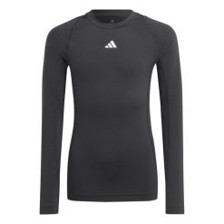 Koszulka adidas Tech Fit Jr. Czarna, dopasowana, z długim rękawem. Czarne topy sportowe damskie Adidas, bez wzorów, z materiału, bez ramiączek. Za 85.99 zł.