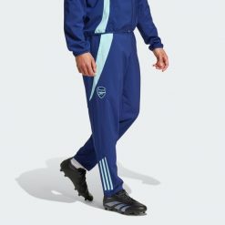 Spodnie Arsenal Tiro 24 Presentation. Niebieskie spodnie dresowe męskie Adidas, bez wzorów, z dresówki. Za 299.00 zł.