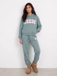 Bluza hoodie oversize z napisem - turkusowy. Niebieskie bluzy bez kaptura damskie Sinsay, l, bez wzorów, bez ramiączek, bez kaptura. Za 49.99 zł.