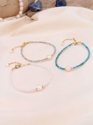 Pierres de Jade Pozłacane bransoletki (3 szt.) z perłami i kryształami rozmiar: onesize. Białe bransoletki damskie Pierres de Jade, pozłacane. Za 30.99 zł.