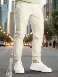 Spodnie jogger - beżowy. Brązowe spodnie materiałowe męskie Sinsay, bez wzorów, z bawełny. Za 59.99 zł.