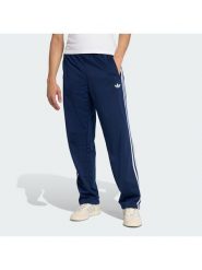 Adidas Spodnie dresowe Firebird KD8316 Granatowy Loose Fit. Niebieskie spodnie dresowe męskie Adidas, bez wzorów, z dresówki. Za 279.99 zł.
