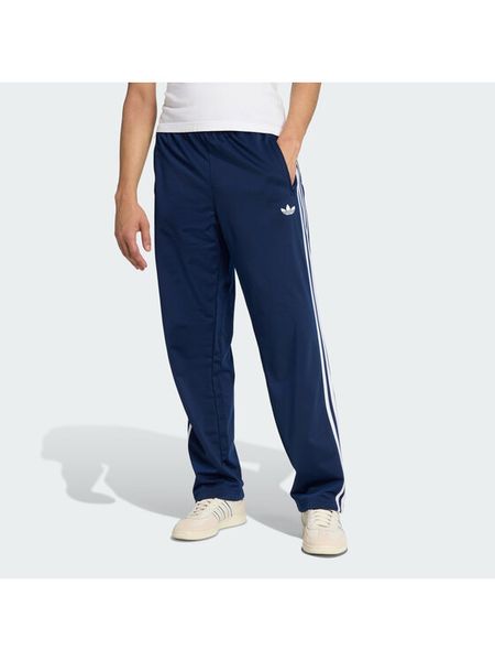 Adidas Spodnie dresowe Firebird KD8316 Granatowy Loose Fit. Niebieskie spodnie dresowe męskie Adidas, bez wzorów, z dresówki. Za 279.99 zł.