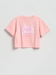 Krótki t-shirt z nadrukiem - brzoskwiniowy. Pomarańczowe koszulki dziewczęce Reserved, bez wzorów, z bawełny, bez ramiączek. Za 39.99 zł.