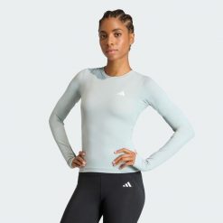 Koszulka Power Essentials Workout Contour Long Sleeve. Zielone bluzki sportowe damskie Adidas, bez wzorów, bez ramiączek. Za 149.00 zł.