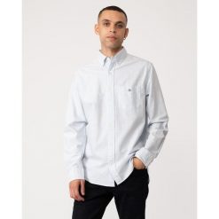 Koszula w paski Gant Classic Oxford. Niebieskie koszule męskie Gant, l, z aplikacjami, z bawełny, bez kołnierzyka, bez ramiączek. Za 493.50 zł.