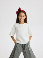 T-shirt z kokardkami - złamana biel. Koszulki dziewczęce Reserved, bez wzorów, z bawełny, bez ramiączek. Za 39.99 zł.