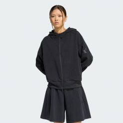 BLUZA Z KAPTUREM SOFT LUX Z SUWAKIEM NA CAŁEJ DŁUGOŚCI. Czarne bluzy sportowe damskie Adidas, xl, bez wzorów, z bawełny, bez ramiączek, z kapturem. Za 349.00 zł.