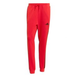 Spodnie do biegania adidas Essentials 3-Stripes. Czerwone spodnie materiałowe męskie Adidas, bez wzorów, z materiału, sportowe. Za 286.50 zł.