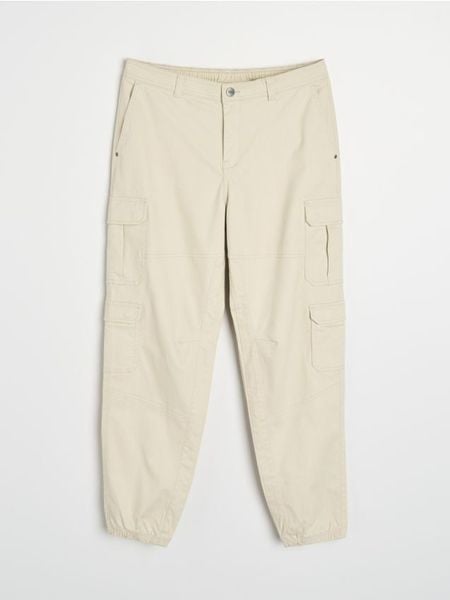 Spodnie cargo jogger - kremowy. Białe spodnie materiałowe męskie Sinsay, bez wzorów. Za 59.99 zł.