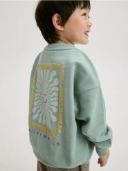 Bluza z nadrukiem SmileyWorld® - miętowy. Zielone bluzy i bluzki niemowlęce Reserved, bez wzorów, z bawełny, bez ramiączek, bez kaptura. W wyprzedaży za 35.99 zł.