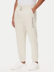 Tommy Hilfiger Spodnie dresowe UM0UM03664 Écru Regular Fit. Spodnie dresowe męskie Tommy Hilfiger, bez wzorów, z bawełny. Za 249.99 zł.