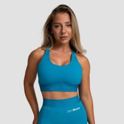Biustonosz sportowy damski fitness regulowany akwamarynowy Limitless. Niebieskie biustonosze sportowe damskie GYMBEAM, bez wzorów, z elastanu. Za 85.90 zł.
