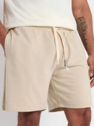 Szorty - beżowy. Brązowe szorty męskie Sinsay, bez wzorów, z bawełny, sportowe. Za 29.99 zł.