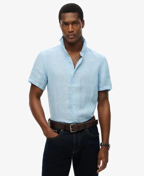 Superdry Koszula Vacation Linen krótki rękaw 100% len Sea Blue Chambray. Niebieskie koszule damskie Superdry., na lato, s, bez wzorów, ze lnu, bez kołnierzyka, bez ramiączek. Za 322.70 zł.