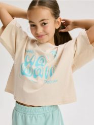 Bawełniany t-shirt z nadrukiem - beżowy. Brązowe koszulki dziewczęce Reserved, bez wzorów, z bawełny, bez ramiączek. W wyprzedaży za 19.99 zł.