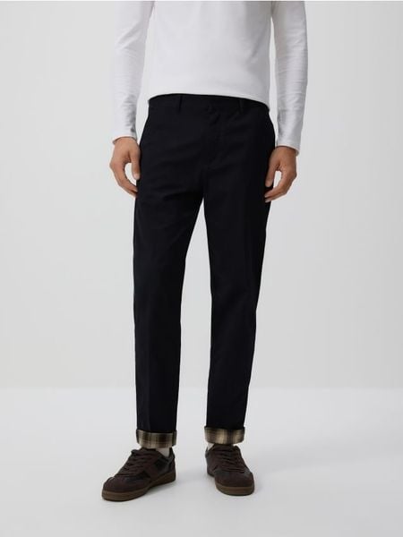 Spodnie carrot slim - czarny. Czarne spodnie materiałowe męskie Reserved, bez wzorów, z bawełny. Za 149.99 zł.
