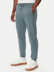Guess Spodnie dresowe Z2YB19 K6ZS1 Niebieski Regular Fit. Niebieskie spodnie dresowe męskie Guess, z aplikacjami, z bawełny. Za 344.99 zł.