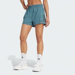 Szorty Own the Run. Niebieskie szorty damskie Adidas, bez wzorów, sportowe. Za 179.00 zł.