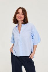 Koszula w paski z bufiastymi rękawami błękitna. Niebieskie koszule damskie MOODO, l, bez wzorów, z bawełny, bez kołnierzyka, bez ramiączek. Za 119.99 zł.