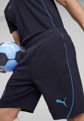 Męskie szorty Casuals Manchester City PUMA New Navy Magic Blue. Niebieskie szorty męskie Puma, z dzianiny, bez kołnierzyka. Za 193.40 zł.