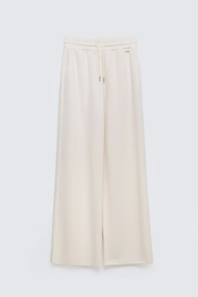 Spodnie damskie dresowe z szeroką nogawką kremowe Lunarap 102. Białe spodnie dresowe damskie Big Star, l, bez wzorów, z dresówki. Za 179.99 zł.