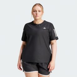 Koszulka Own The Run (Plus Size). Czarne bluzki damskie Adidas, plus size, bez wzorów, z materiału, bez ramiączek. W wyprzedaży za 104.30 zł.