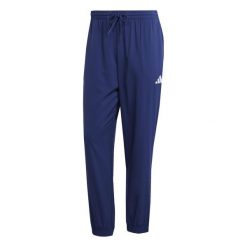 Spodnie do biegania adidas ESSENTIALS SMALL LOGO STANFORD. Niebieskie spodnie materiałowe męskie Adidas, bez wzorów, z materiału, eleganckie. Za 186.00 zł.