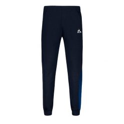Spodnie Slim-fit Le Coq Sportif Heritage SP N°1. Niebieskie spodnie materiałowe męskie Le Coq Sportif, bez wzorów, z bawełny, eleganckie. Za 331.40 zł.