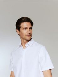 Elegancka koszula regular fit - biały. Białe koszule męskie Reserved, l, bez wzorów, z bawełny, bez kołnierzyka, bez ramiączek. Za 99.99 zł.