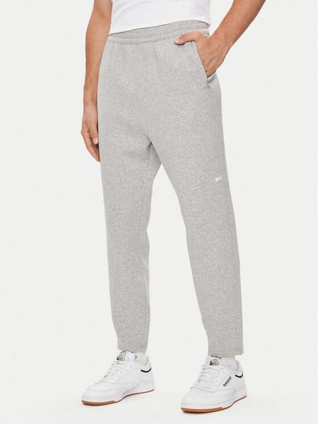 Reebok Spodnie dresowe Activ Coll Dreamblend 100075606 Szary Regular Fit. Szare spodnie dresowe męskie Reebok, bez wzorów, z bawełny. Za 309.99 zł.