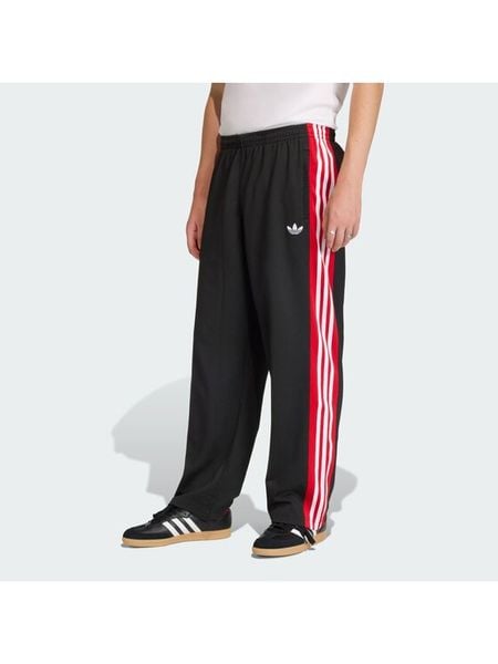 Adidas Spodnie dresowe KE0117 Czarny Loose Fit. Czarne spodnie dresowe męskie Adidas, bez wzorów, z dresówki. Za 226.99 zł.