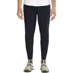 Spodnie męskie Puma Run Tapered Woven Pant. Czarne spodnie sportowe męskie Puma, bez wzorów, z materiału, sportowe. Za 178.56 zł.