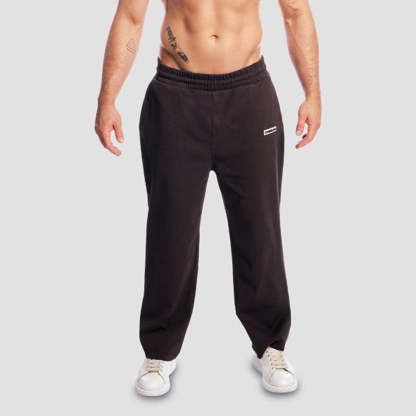 Spodnie dresowe męskie oversize brązowe Aura. Brązowe spodnie sportowe męskie GYMBEAM, z bawełny. Za 139.90 zł.